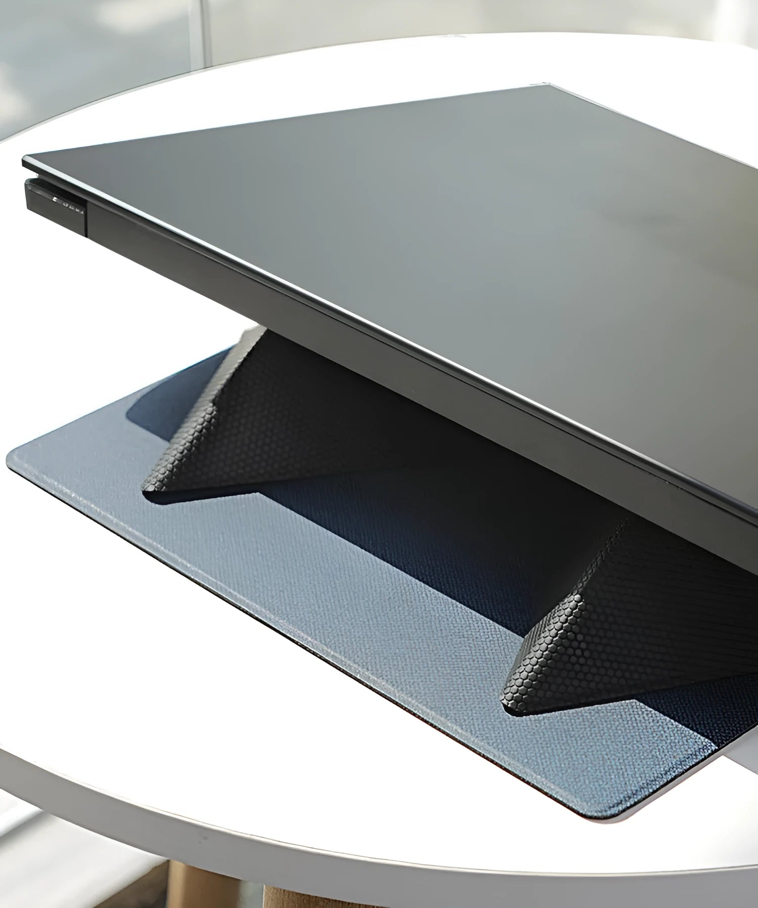 Portable non-slip cooling bracket for laptop with ergonomic design in blue, folded with built-in magnet