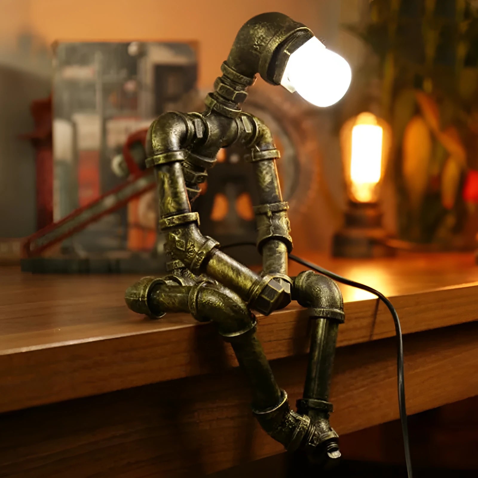 Green bronze vintage industrial iron pipe desk lamp on a wooden table.