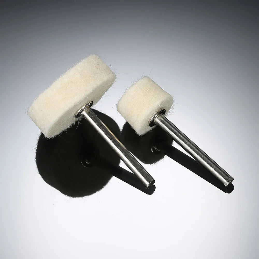 Polishing wheel accessories 129-piece set with white wool brushes and metal grinding wheels on a workbench