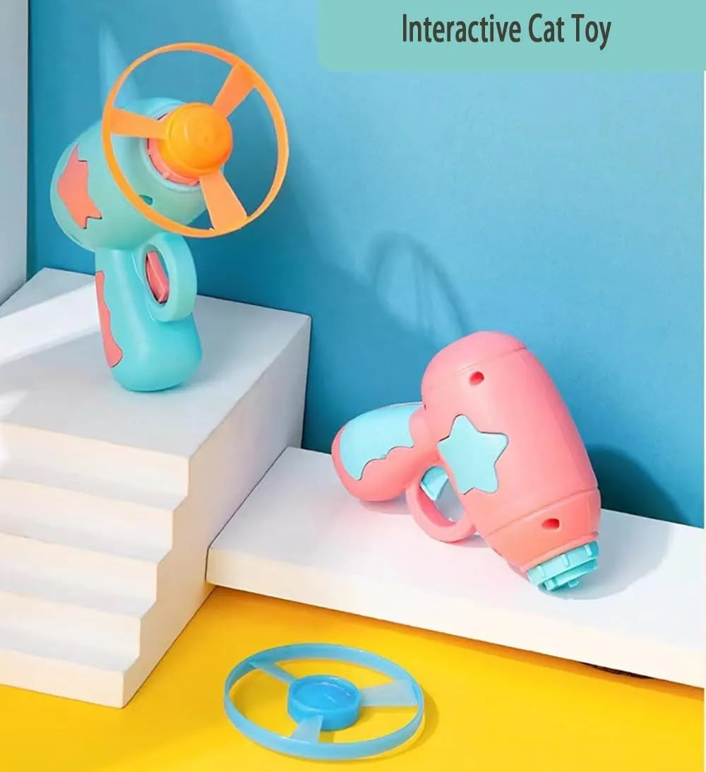 Blue interactive cat toy gun with plastic frisbee mounted ready for launching
