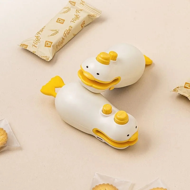Yellow rechargeable handheld sealing machine with small duck design on animal jacquard casing.