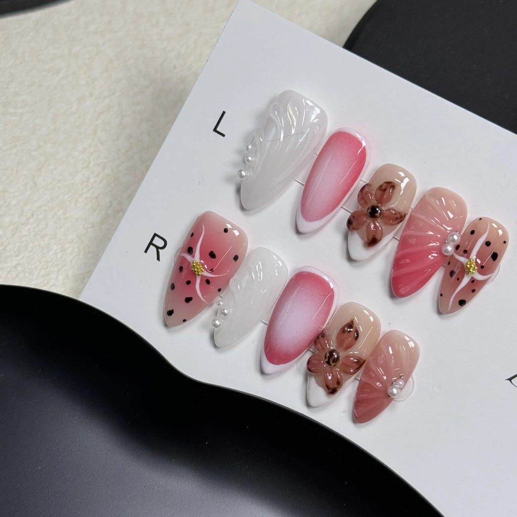 Hand-painted 3D candy pattern false nail art patches in almond shape on a plastic set.