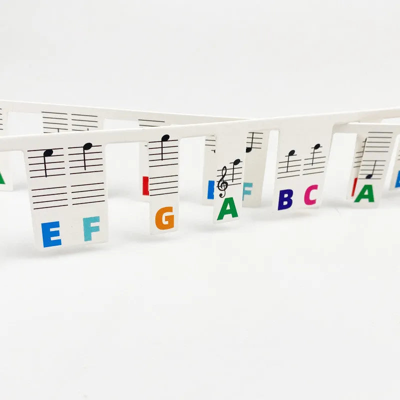 White cardboard piano keyboard stickers for 88-key staff notation learning with coloured note bars