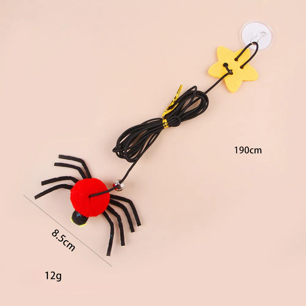 Red and yellow cat hanging door toy with elastic rope, feather, bell, and spider decoration.