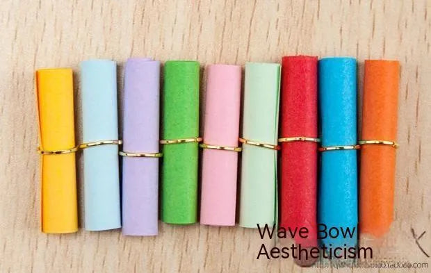 Assorted coloured miniature paper scrolls for drift bottle messages, showing pre-punched hole.