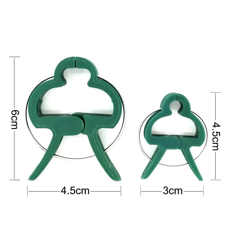 Green plastic plant fixing clips for supporting climbing vegetables like tomatoes and cucumbers