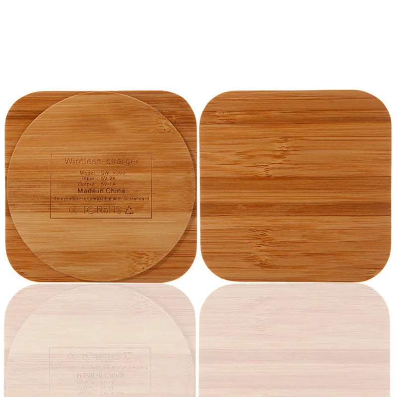 Square wooden bamboo 5W Qi wireless charging pad on a desk next to a smartphone.