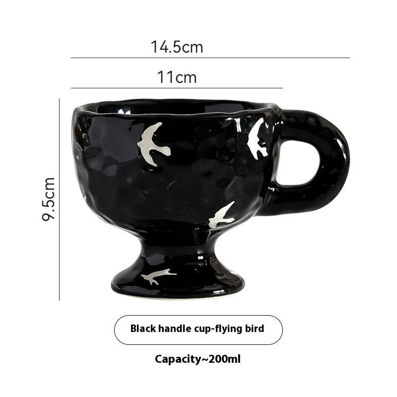Hand-pinched irregular shaped ceramic mug in a solid colour on a table.