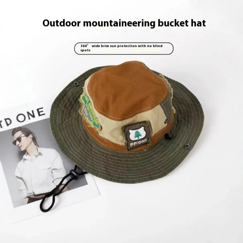Army green cotton fisherman hat with patchwork details and flat-top crown, folded for display