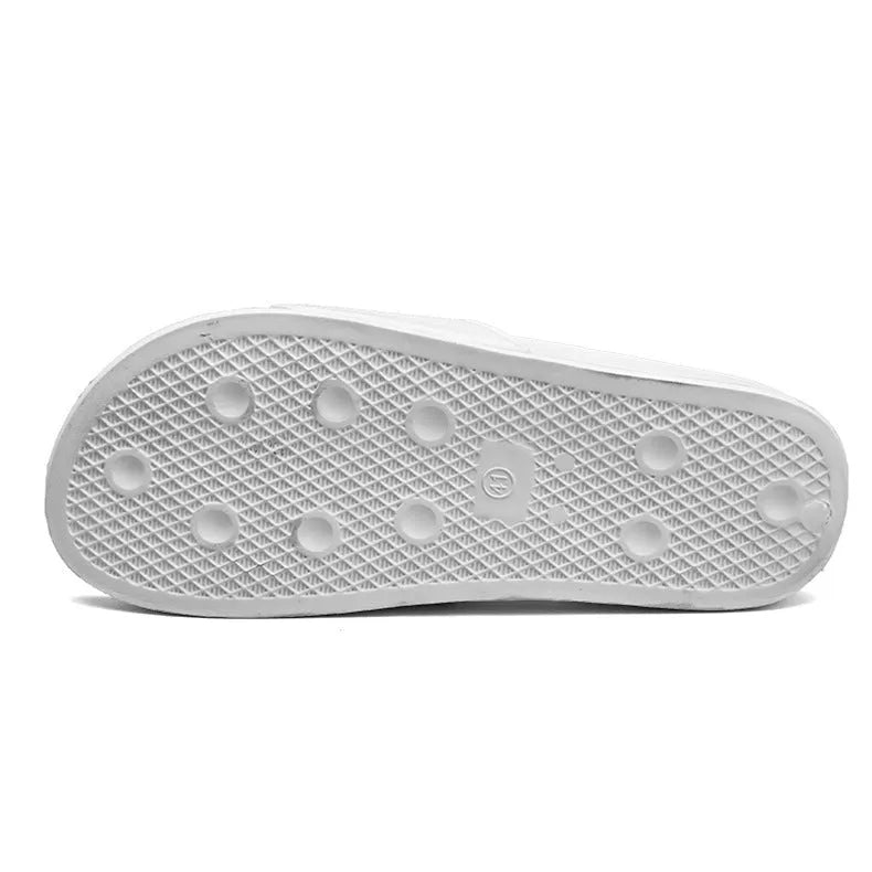 Men's black and white open-toe slippers with a textured rubber sole on a plain background
