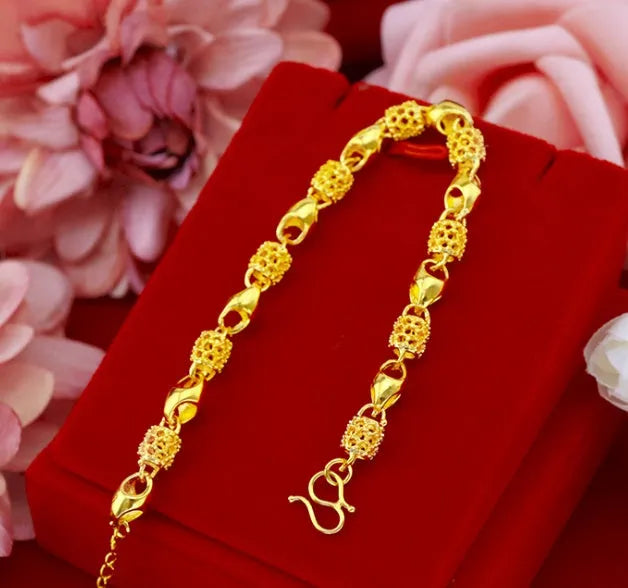 Gold-plated brass bracelet with thick vacuum gold coating on a white background