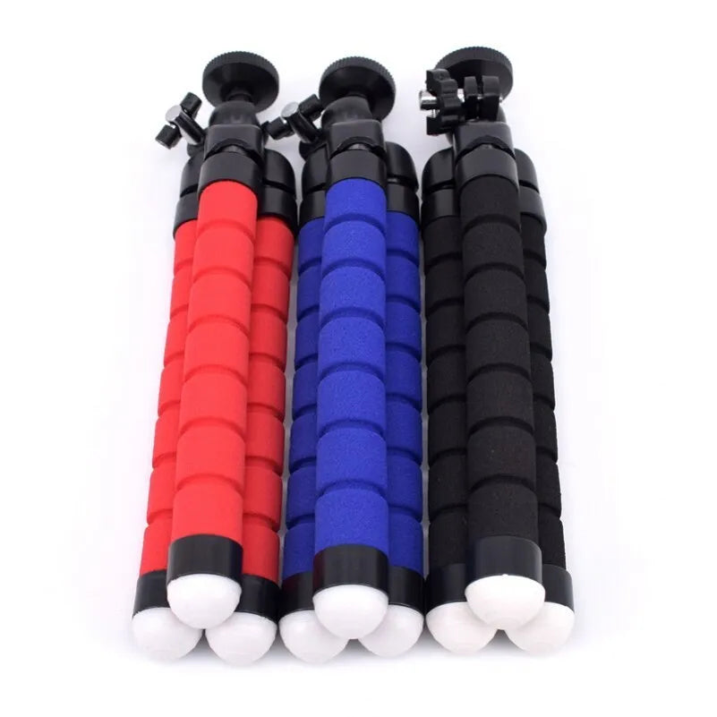Black flexible octopus tripod with bent legs wrapped around a pole, showing smartphone mount with 1/4-20 screw.