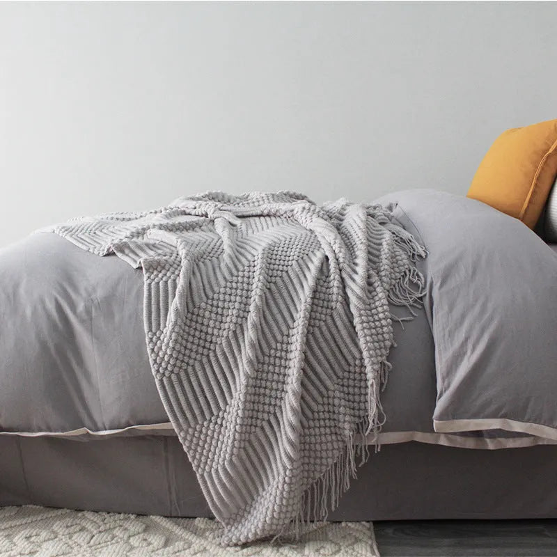 Small light grey polyester nap blanket folded, showing its 127x170cm size.