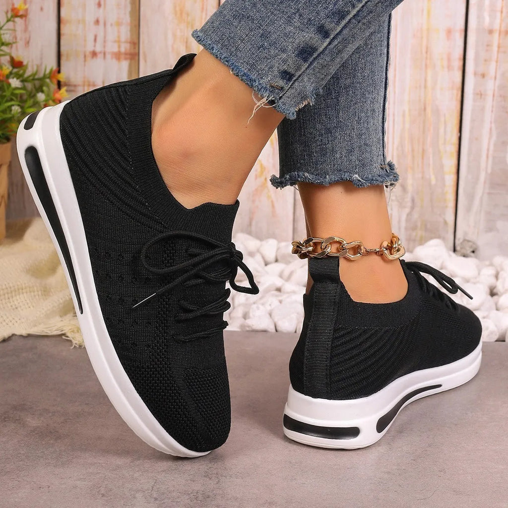 Women's low-top casual sneakers in red, black, or blue with round toe and front lace-up design.