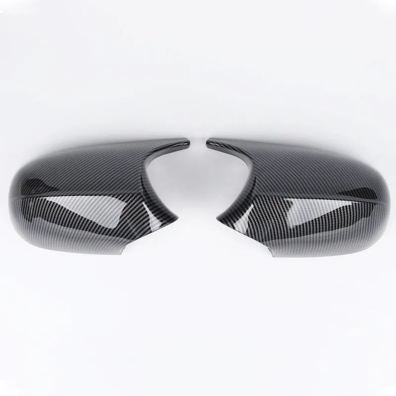 Pair of black ABS plastic rearview mirror housings for BMW 3 Series E90 on a white background.