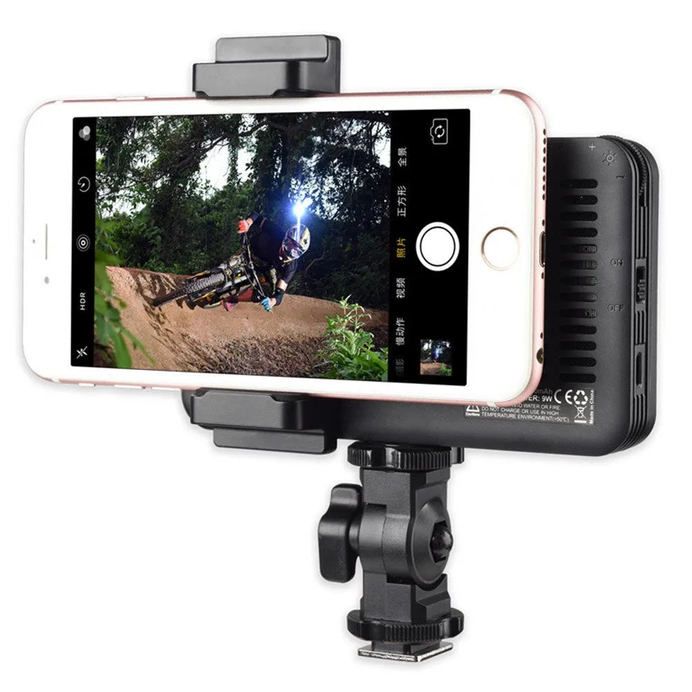Shenniu M150 ultra-thin LED video light mounted on a mobile phone with L-bracket.