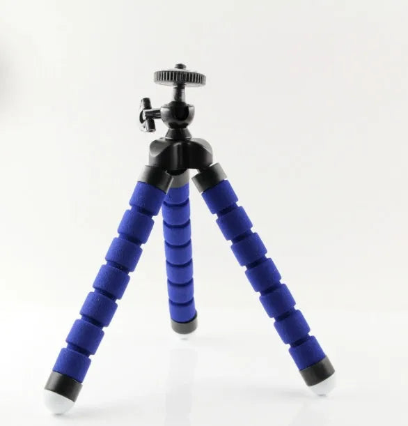 Black flexible octopus tripod with bent legs wrapped around a pole, showing smartphone mount with 1/4-20 screw.