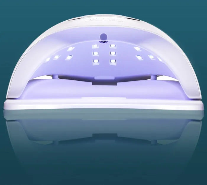 White nail drying lamp with UV and LED lights showing digital timer display