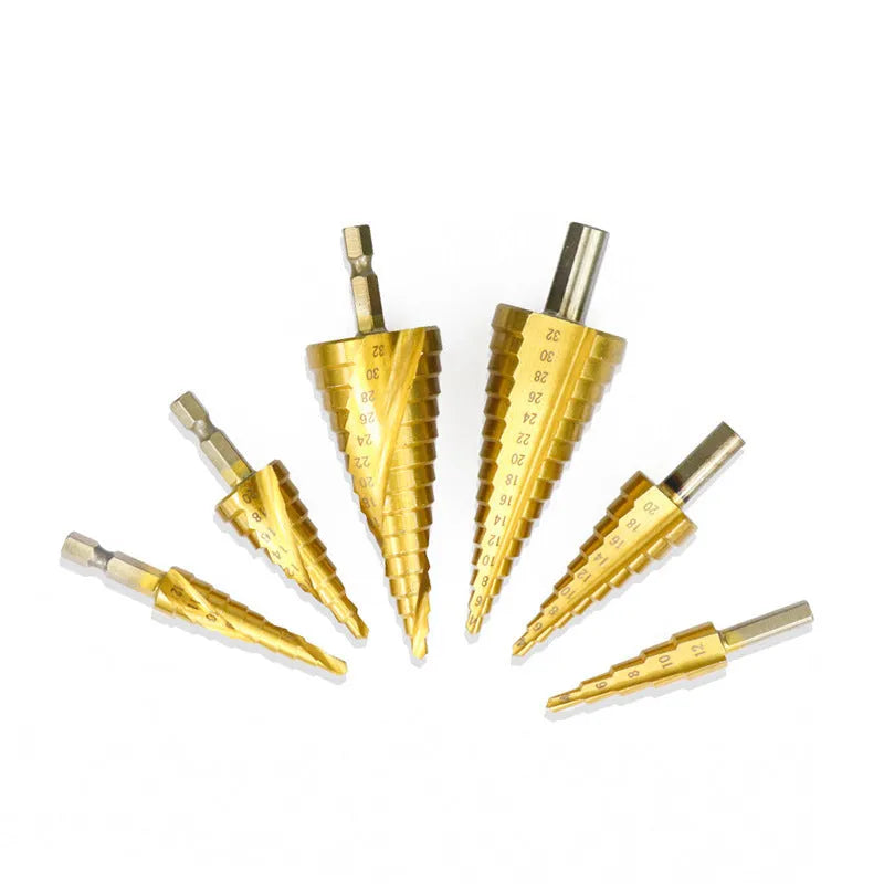 High-speed steel cone step drill bits and a centre punch set on a workshop bench