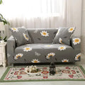 Geometric patterned stretch sofa slipcover fitted on a modern two-seater sofa.