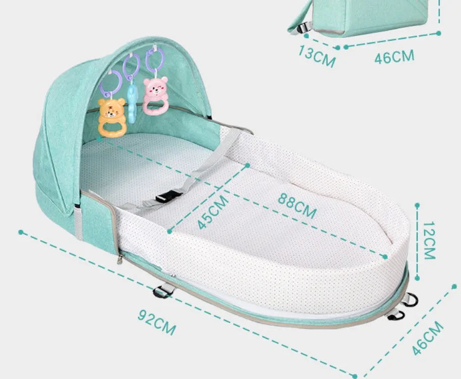 Portable foldable baby anti-mosquito isolation bed with grey cotton linen fabric, open on a grassy area