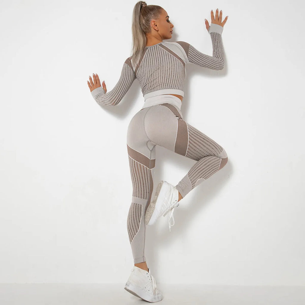 Women's long-sleeved seamless knitted yoga suit in a neutral colour, showing the stretch fabric and close fit.