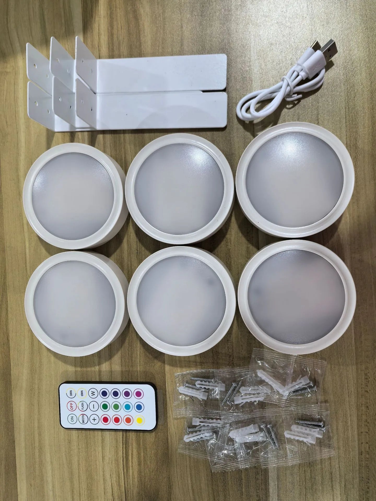 Wireless rechargeable LED painting lamp with magnetic belt attached to a metal frame, remote control nearby.