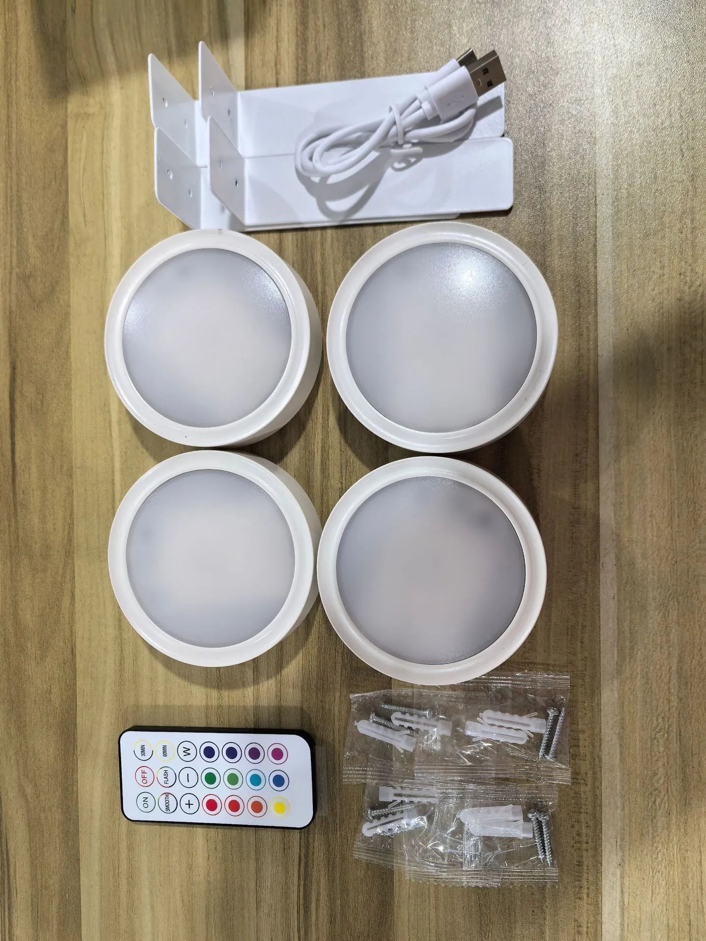 Wireless rechargeable LED painting lamp with magnetic belt attached to a metal frame, remote control nearby.