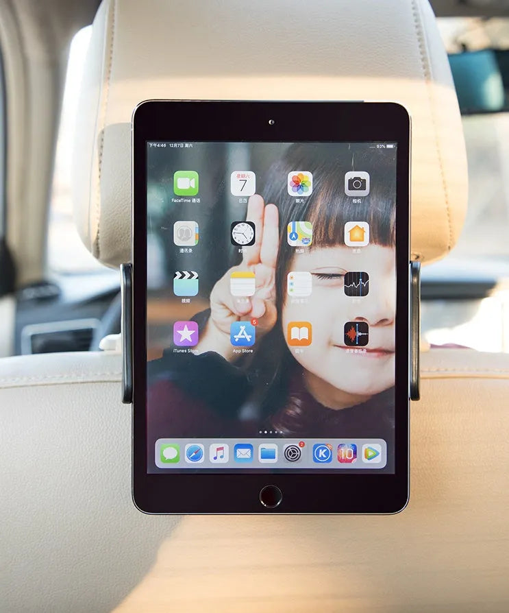 Black universal car phone holder mounted on a car rear seat base, holding a tablet for navigation