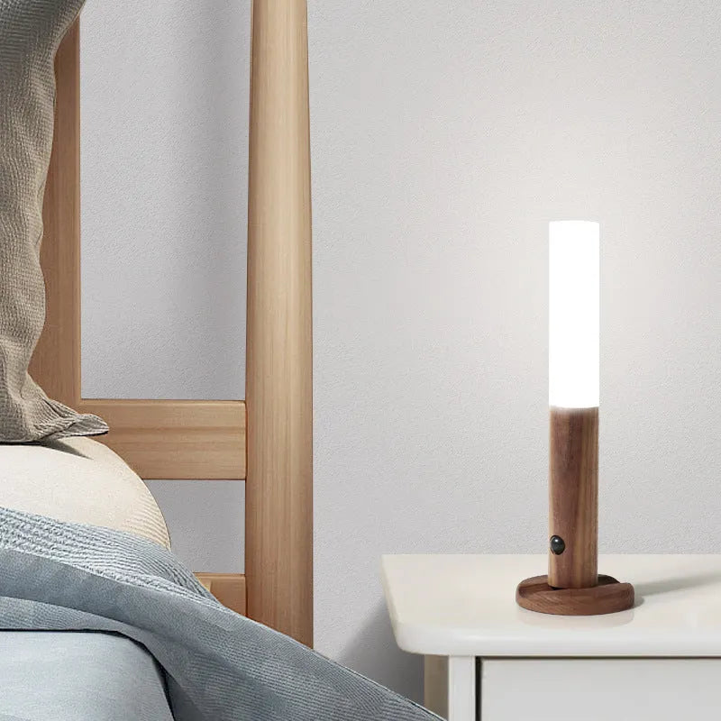 Smart sensor LED desk lamp in wood and acrylic glass on a desk.