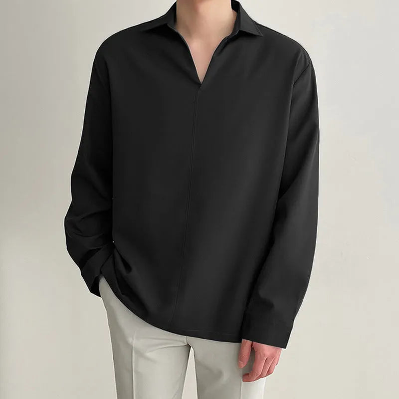 Man wearing a loose lapel pullover casual shirt in a light business style.