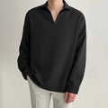 Man wearing a loose lapel pullover casual shirt in a light business style.