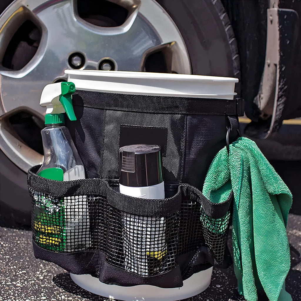 Black cylindrical polyester storage bag hanging on a 5 gallon barrel for tools and toiletries.