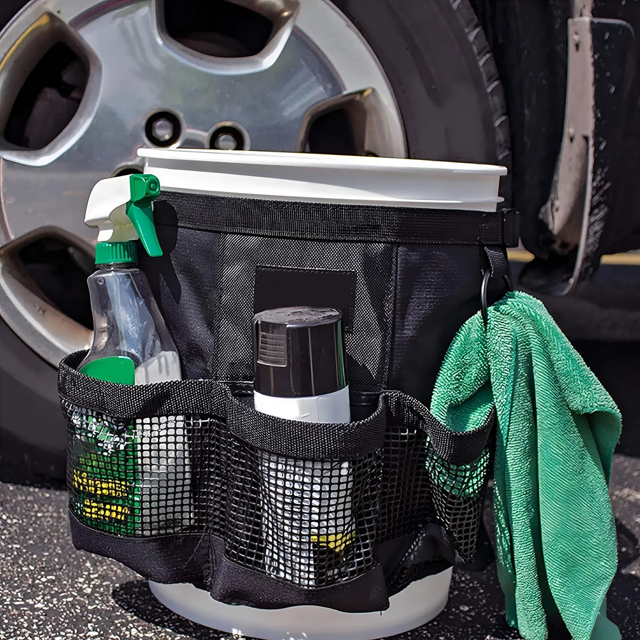 Black cylindrical polyester storage bag hanging on a 5 gallon barrel for tools and toiletries.