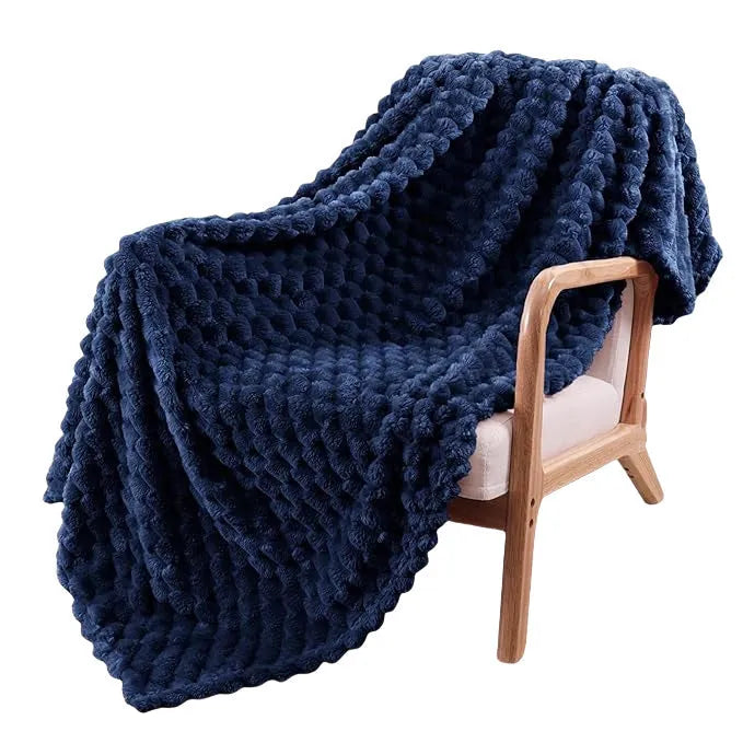 Children's soft plaid fleece blanket in camel colour showing texture and size.