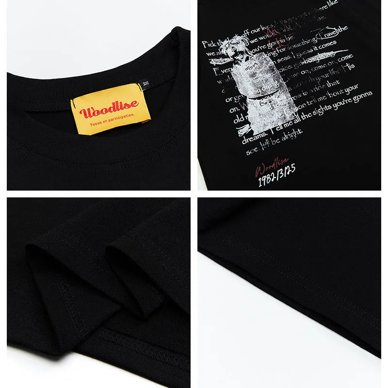 Man modelling a black loose-fit pure cotton T-shirt with a white printed letter pattern and raglan short sleeves