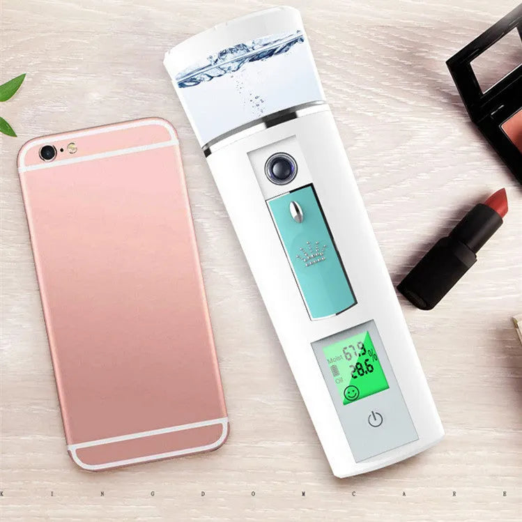 White rechargeable USB portable facial moisturiser spray 15cm by 4.5cm on a table