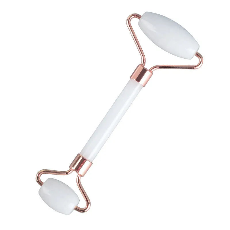 White jade double-headed facial roller and gua sha scraping tool set with a wooden storage board.