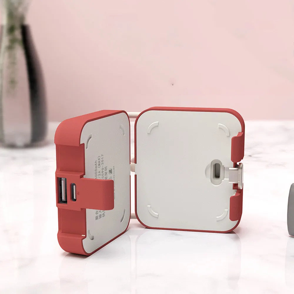Handbag back clip power bank in blue, showing clip detail and phone standing in its holder mode.