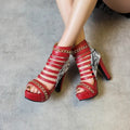 Women's black fish mouth high-top shoes with a snake skin upper and a thick Roman block heel.