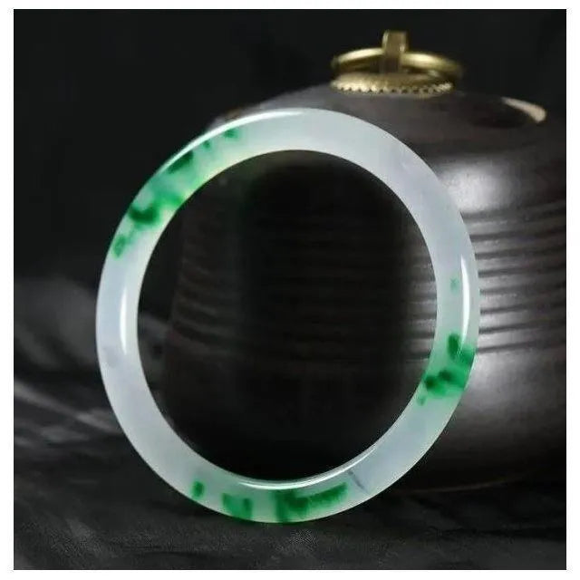 Women's jade bracelet with floating flower design in ice-like emerald appearance