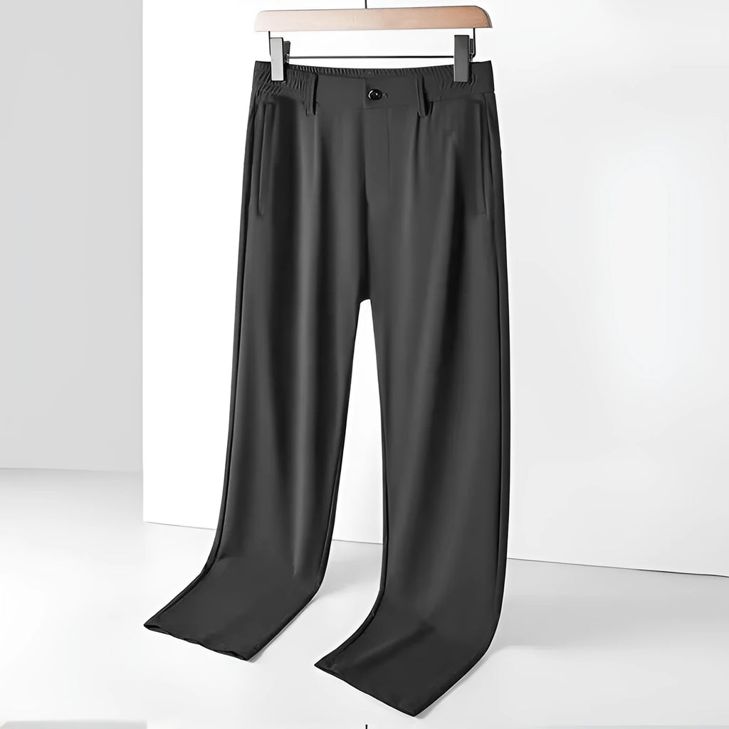 Men's black ice silk leisure trousers with elastic waist and straight leg design laid flat