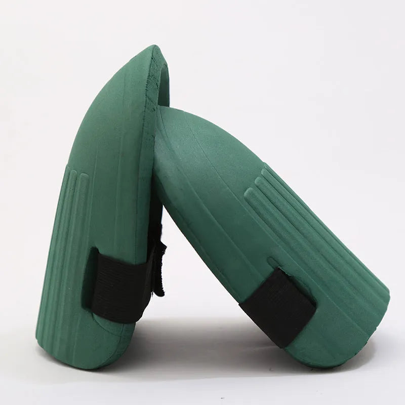 A pair of thick EVA foam knee pads in army green colour on grass.