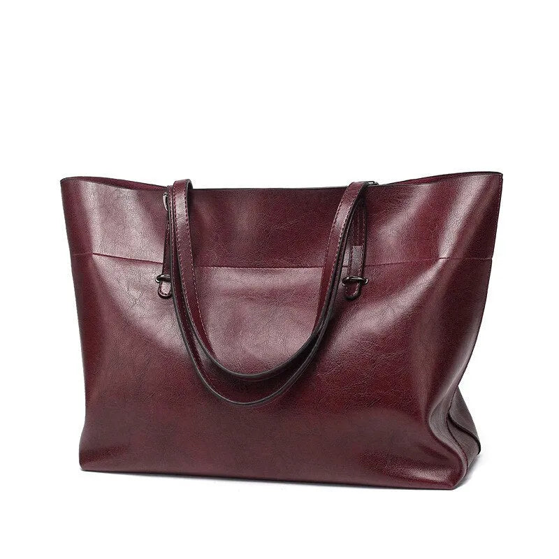 Brown wax cowhide leather handbag showing internal compartments and crossbody strap