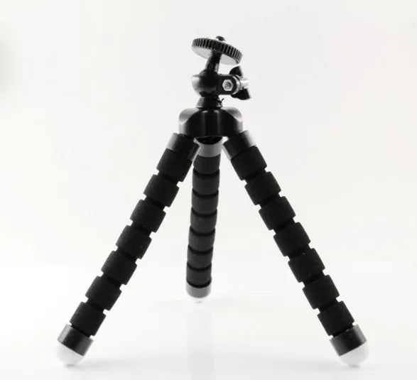 Black flexible octopus tripod with bent legs wrapped around a pole, showing smartphone mount with 1/4-20 screw.