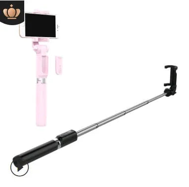 Aluminium Bluetooth selfie stick with tripod base and remote control next to a smartphone.