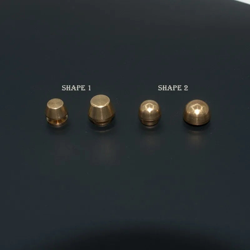 Brass decorative foot nail buckles in round and bucket shapes, sizes 10x6mm and 12x7mm.