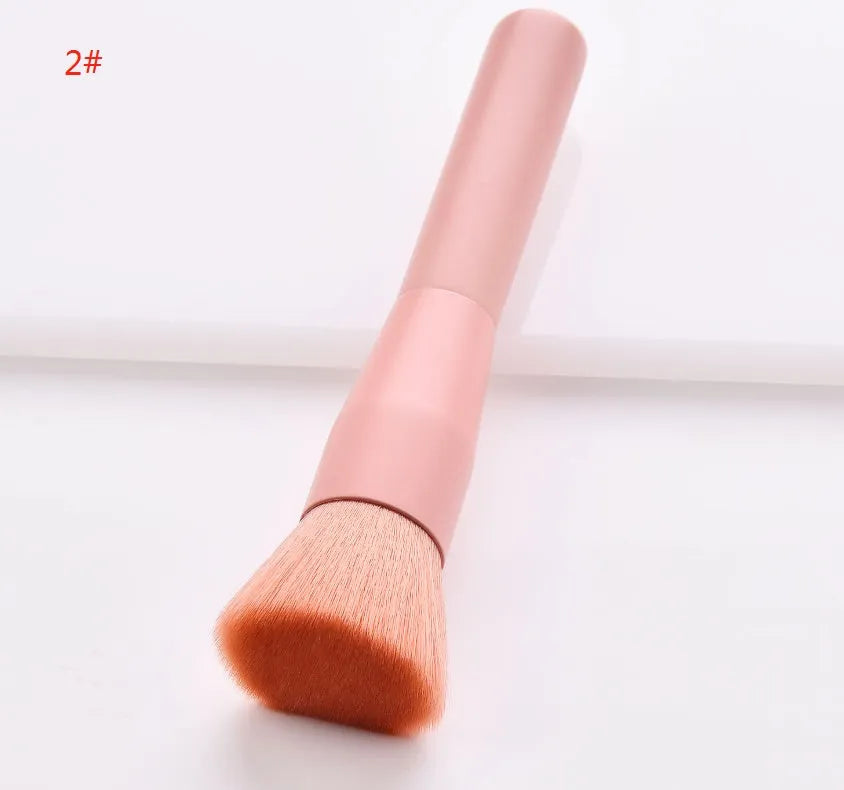 Ten makeup brushes with wooden handles arranged showing different brush head types including powder, foundation and double-headed tools