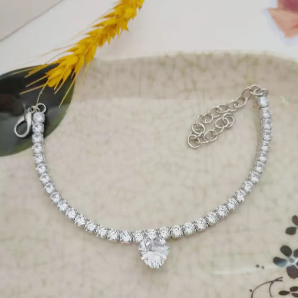 Gold pet collar with a heart shape covered in shiny rhinestones for dogs and cats.