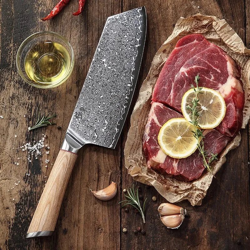 Damascus kitchen knife set with multiple blade sizes and V gold steel core on a kitchen counter.